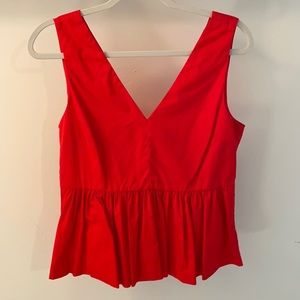 Red tank top. Double v. Ruffled bottom
